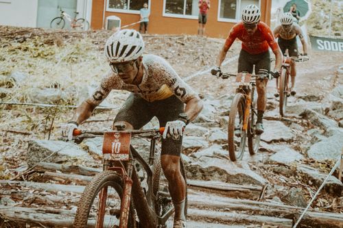 Free Mountain bikers racing on challenging rocky terrain outdoors during the day. Stock Photo