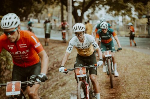 Free A group of professional cyclists competing in an outdoor race on a rainy day. Stock Photo