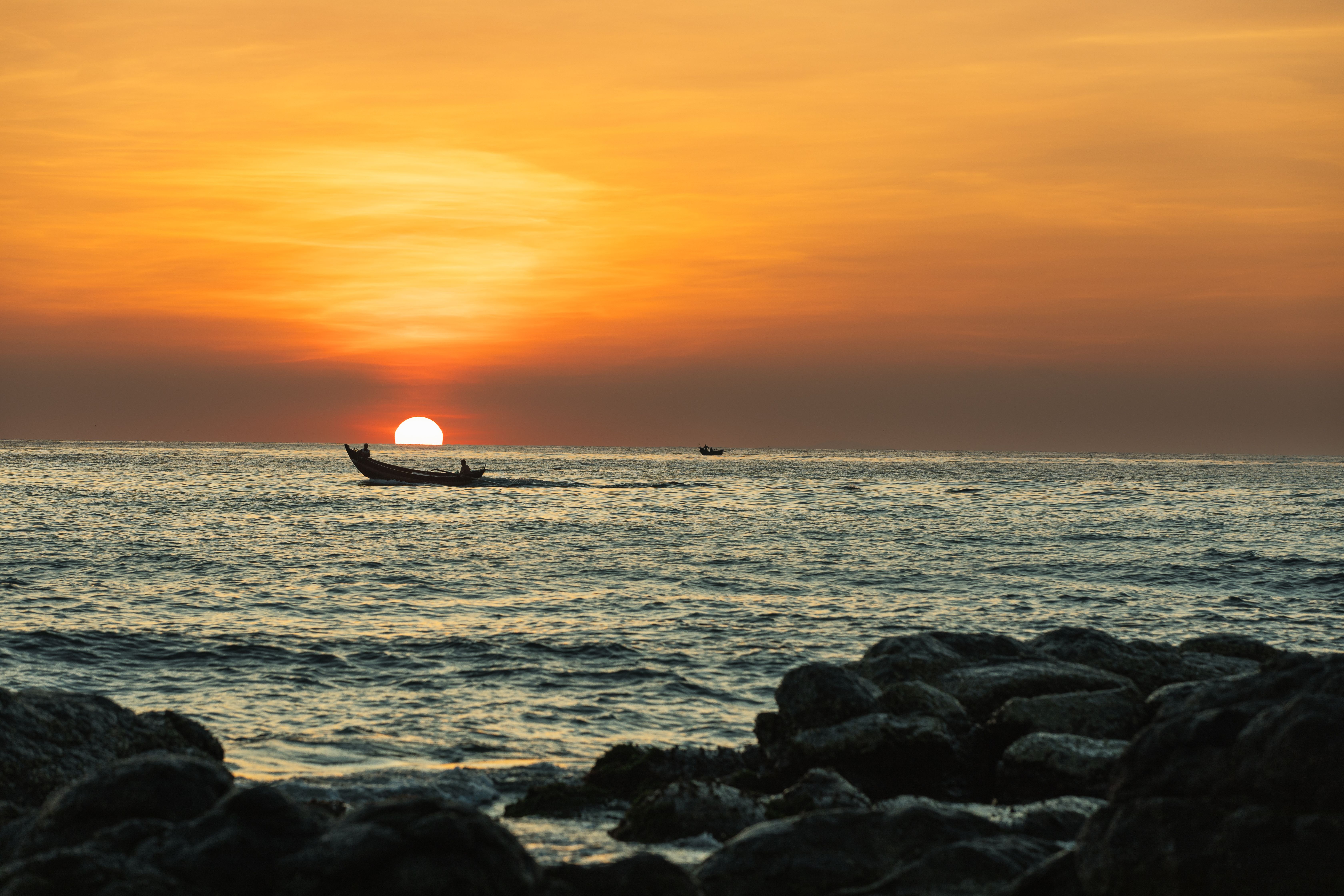 A tranquil boat ride during sunset over the sea at Cửa Tùng Beach, Vietnam.