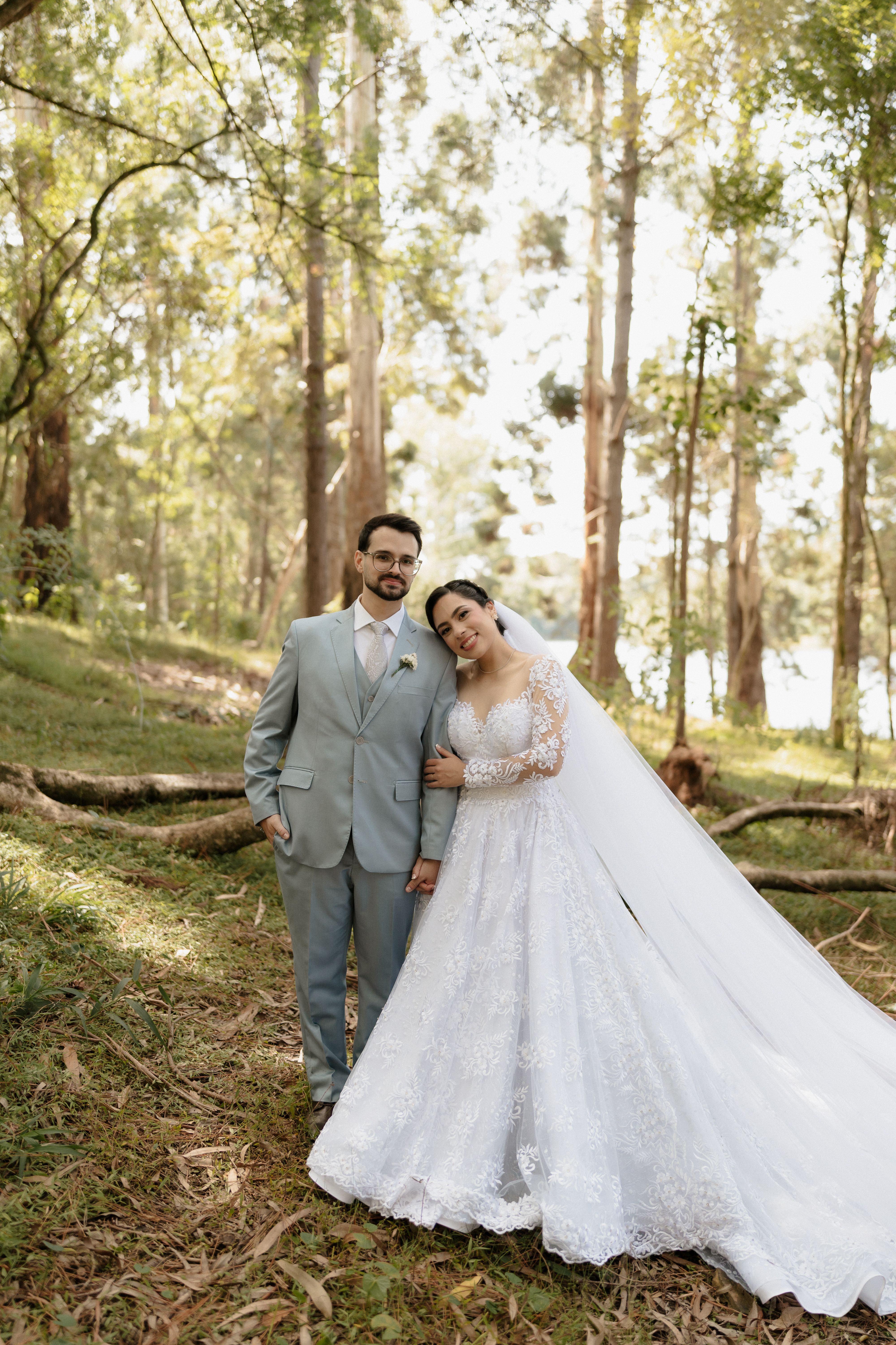 Elegant wedding couple in a forest setting, exuding romance and tranquility.