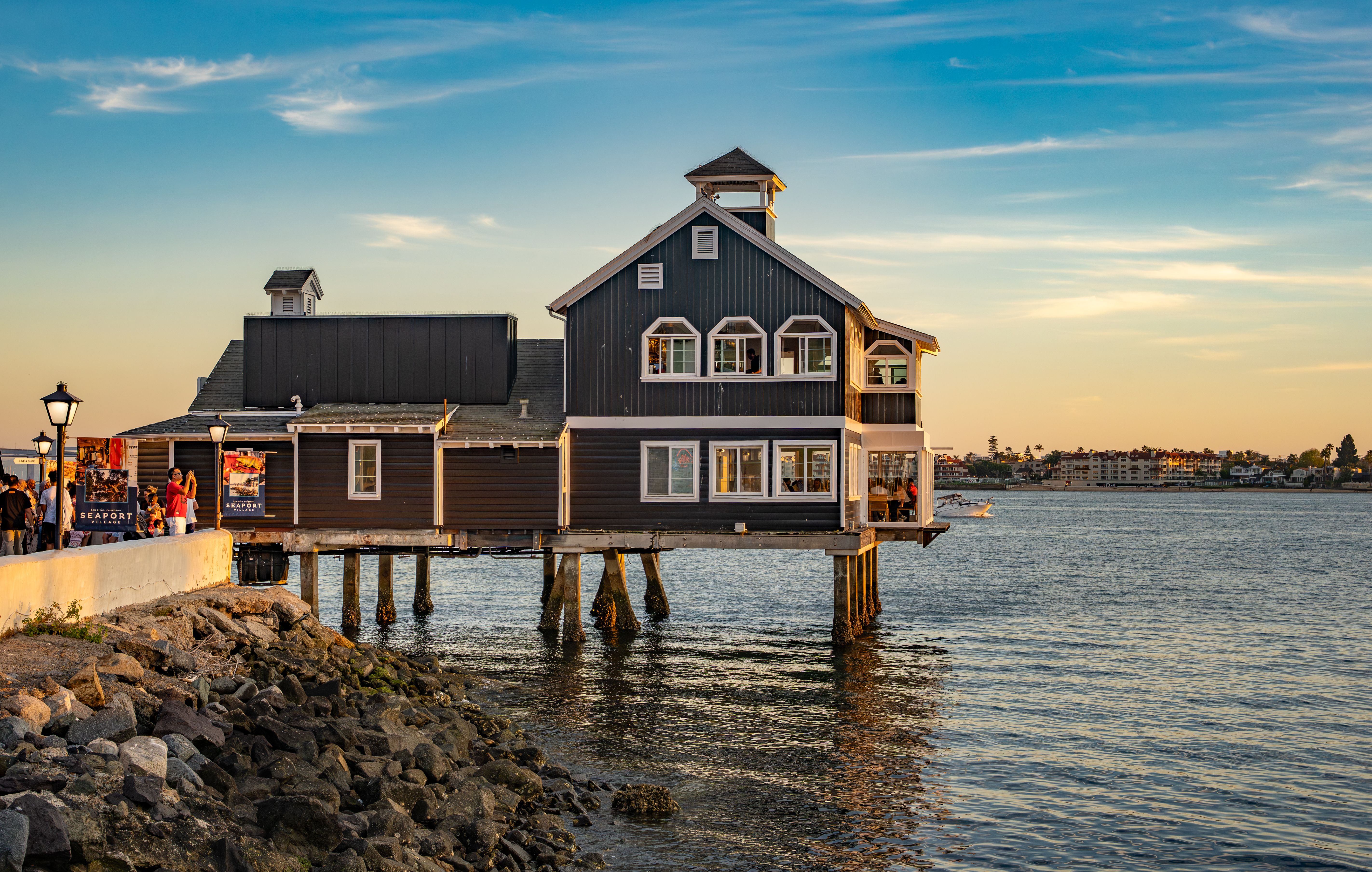 Shorebird Restaurant overlooking San Diego Bay during sunset, a picturesque waterfront dining scene.