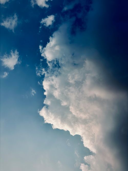 Free Capture of fluffy white clouds against a deep blue sky, ideal for weather or nature themes Stock Photo