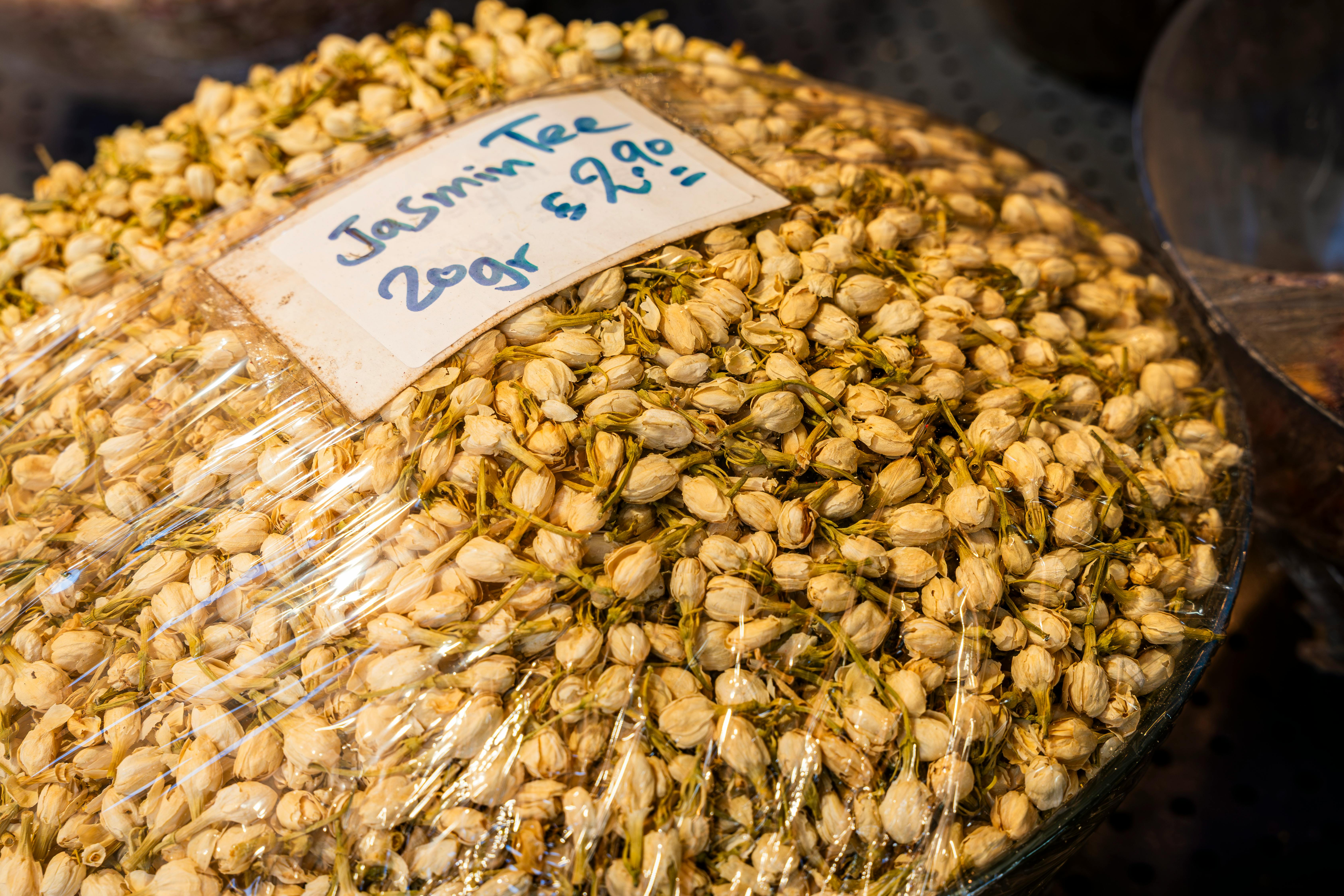 Close-up of a packaged jasmine tea display with price and weight.