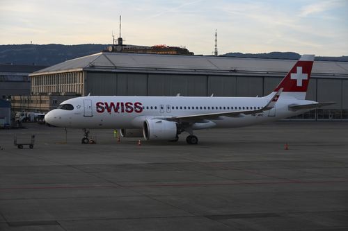 Free Swiss Airbus A320 at Genève Airport during sunset, showcasing Swiss aviation excellence. Stock Photo