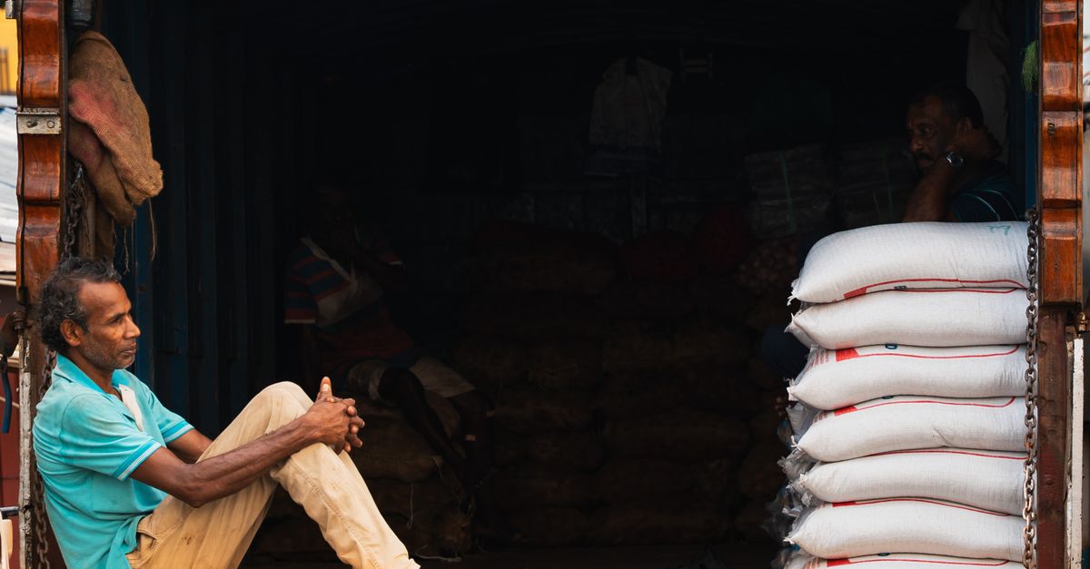 A street vendor in Pettah, Colombo, takes a moment of rest by his goods, depicting the daily life in Sri Lanka.