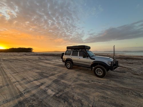 Free Explore off-road adventure in a 4WD at stunning Rainbow Beach during a breathtaking sunrise. Stock Photo