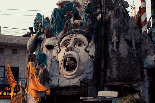 Intricate facade featuring a large dramatic sculpture on a street in Ludhiana, Punjab, India.