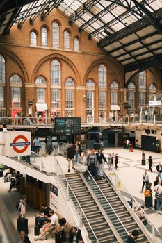 Liverpool Street Station's vibrant interior with commuters and historic architecture.