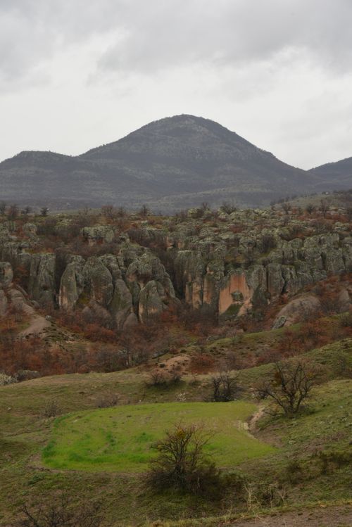 Free Tranquil scene of rocky hills and mountains under a cloudy sky. Stock Photo