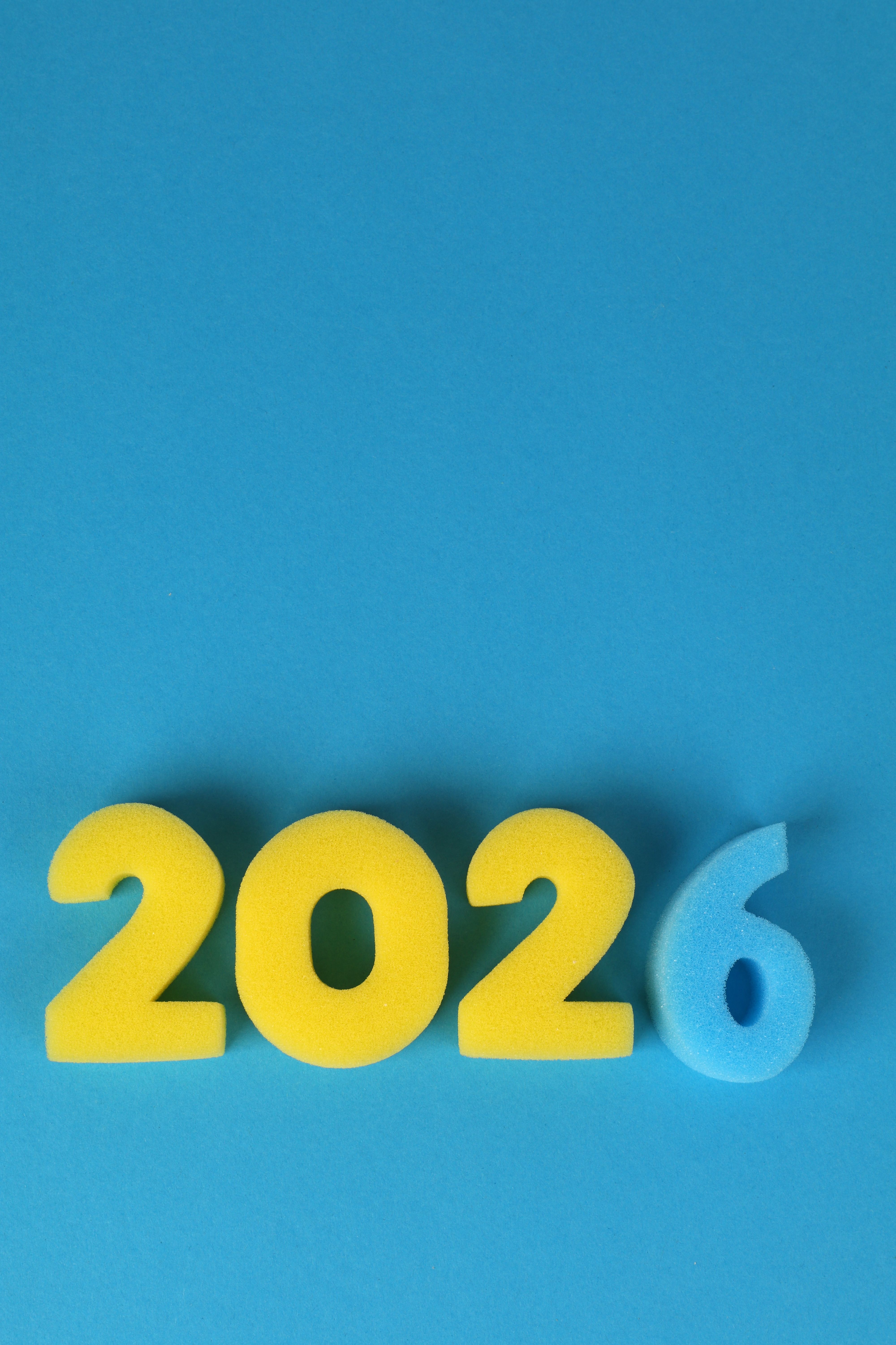 Vibrant foam numbers forming 2026 on a blue background. Perfect for New Year content.