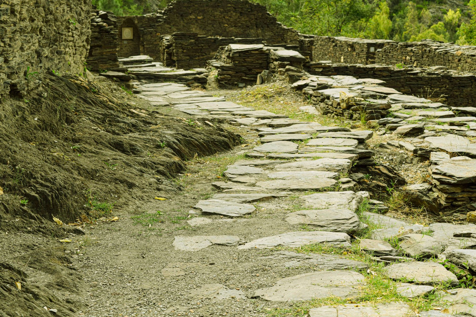 Explore the historic stone pathway in Odigram, Pakistan, leading through ancient ruins.