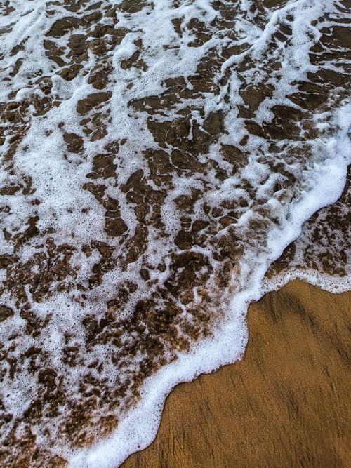 Free Close-up of ocean waves washing over the sandy beach in Casablanca, Morocco. Stock Photo