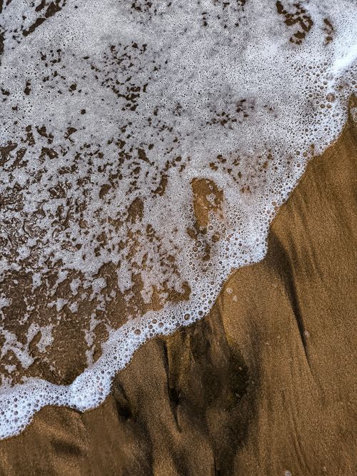 Free Close-up of ocean waves washing over sandy coastline in Casablanca, Morocco. Stock Photo