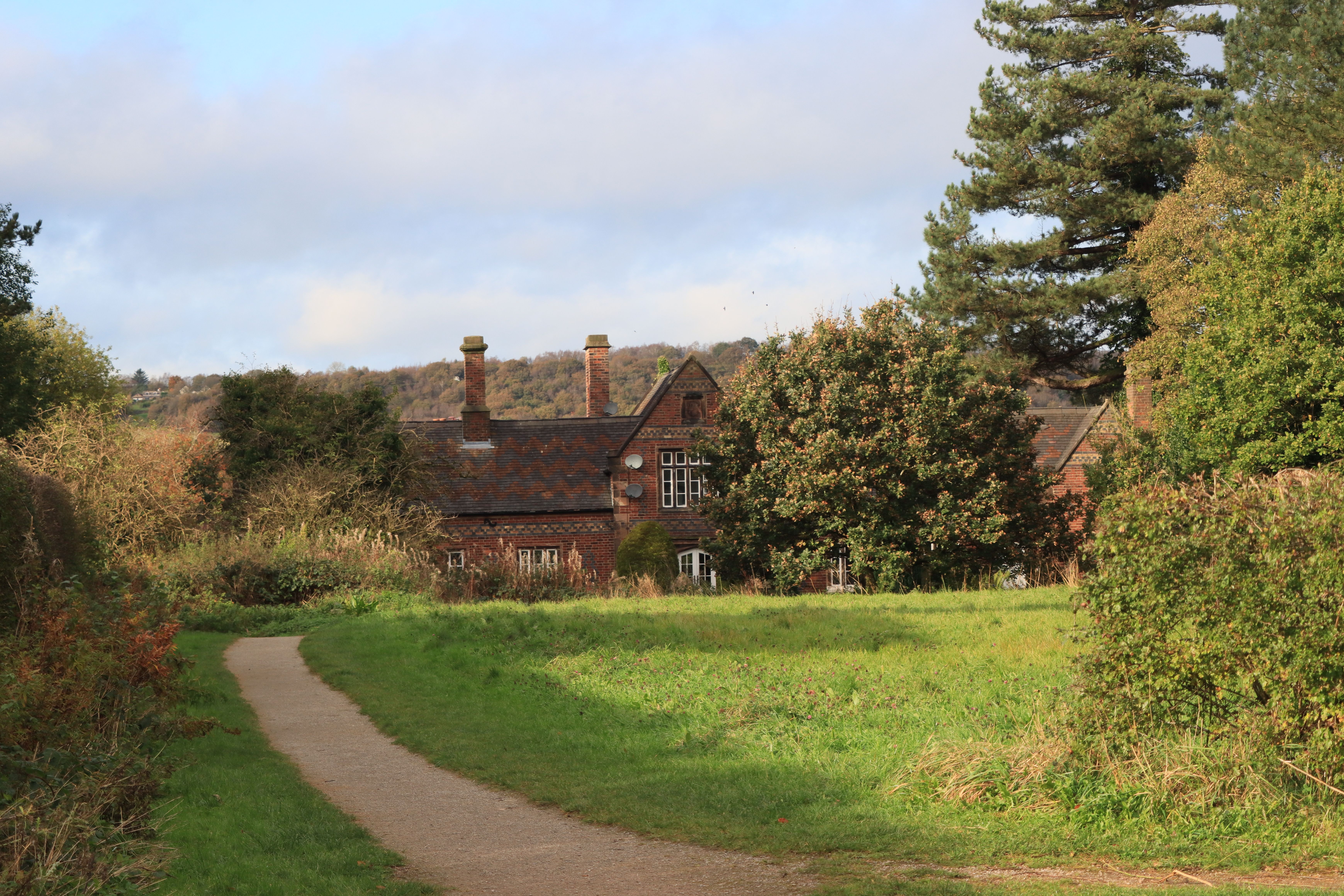 Picturesque view of a traditional English cottage surrounded by lush greenery in Biddulph.