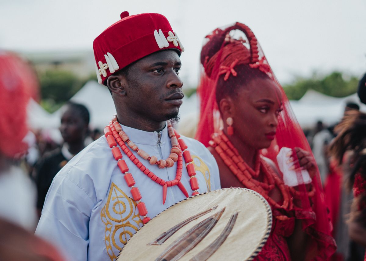 A vibrant Nigerian traditional wedding with colorful attire and cultural drums