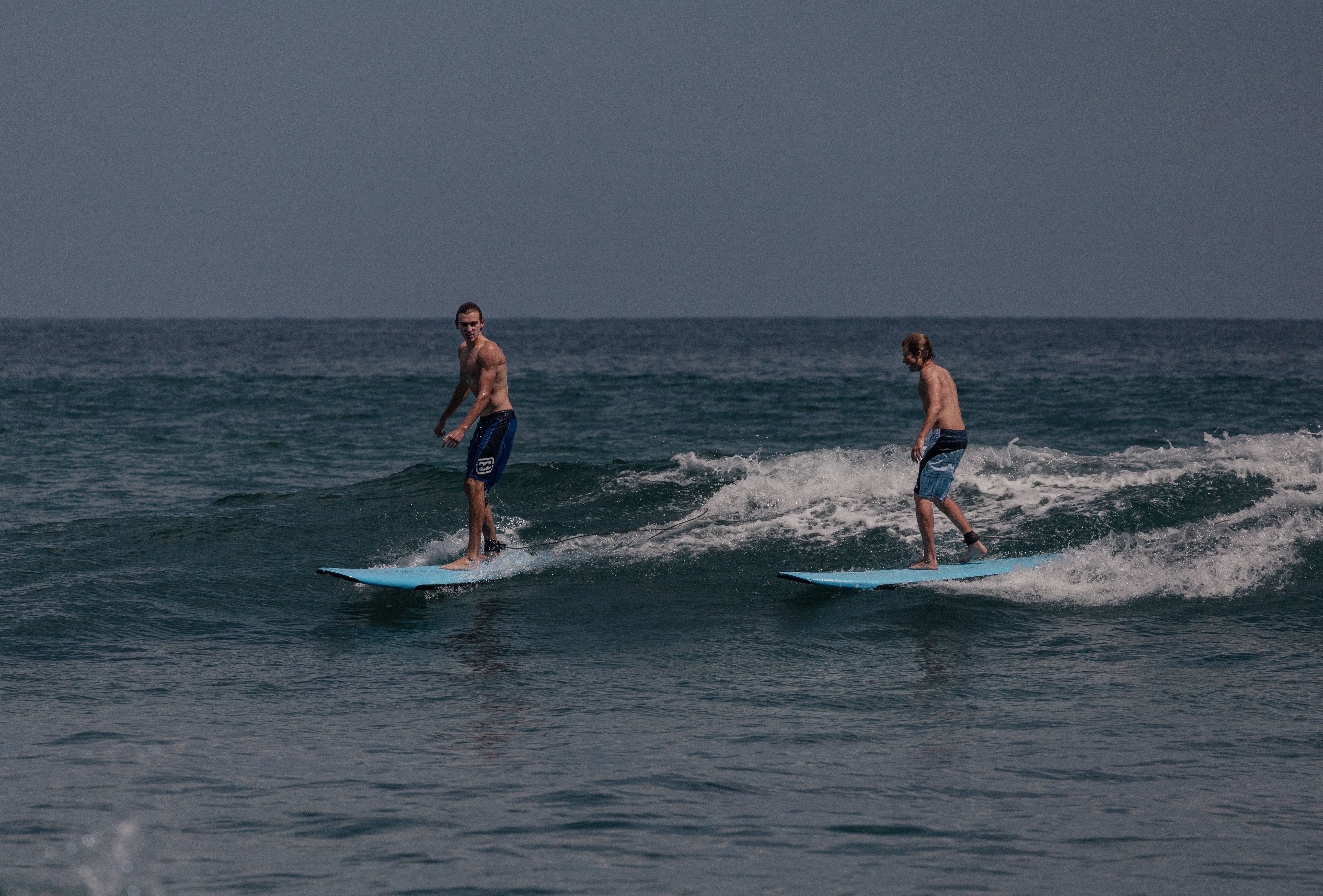 Two surfers enjoying waves in Cabo San Lucas, Baja California Sur, Mexico.