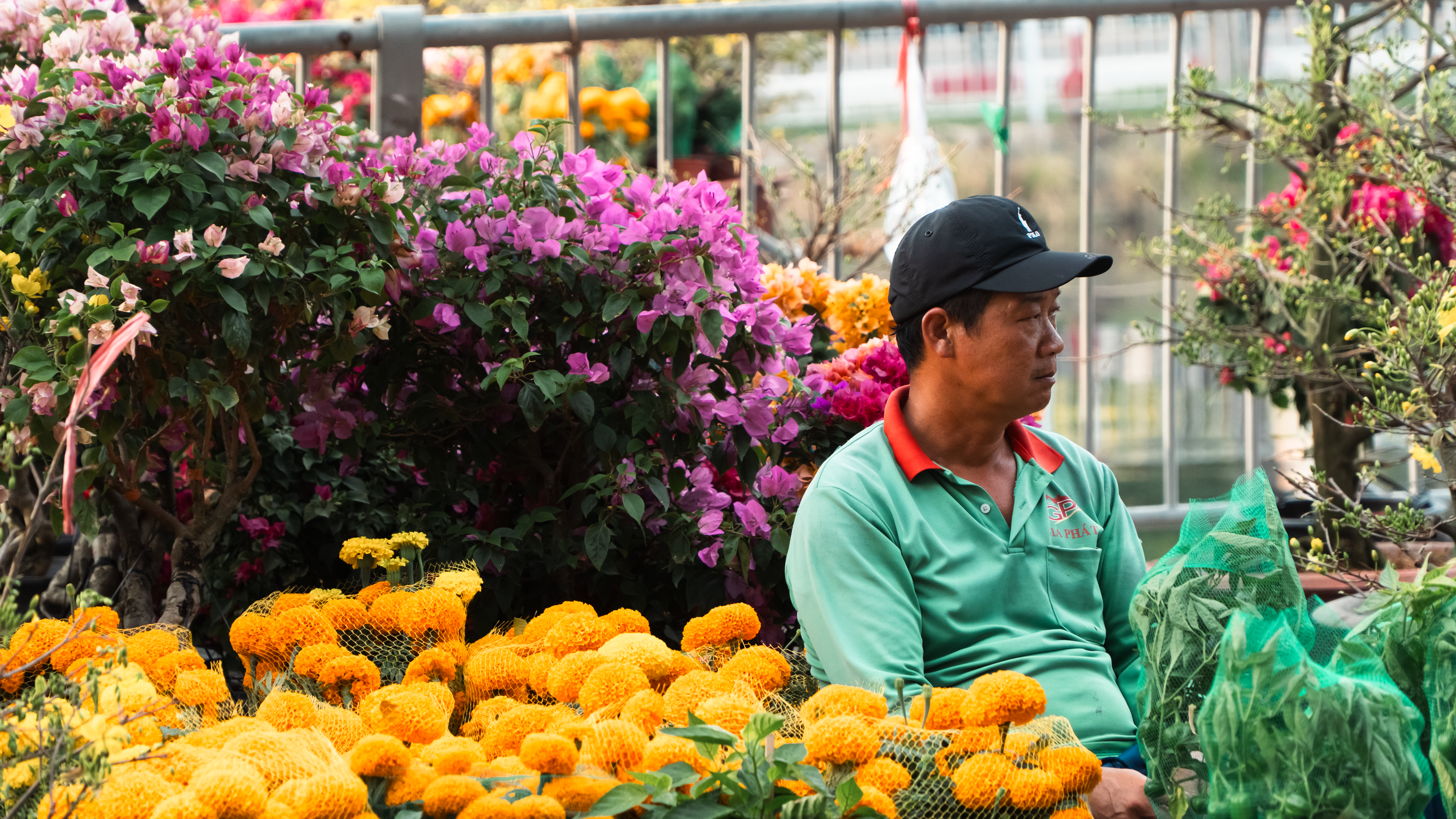Early morning flower sellers outside Dadar station with baskets of marigolds