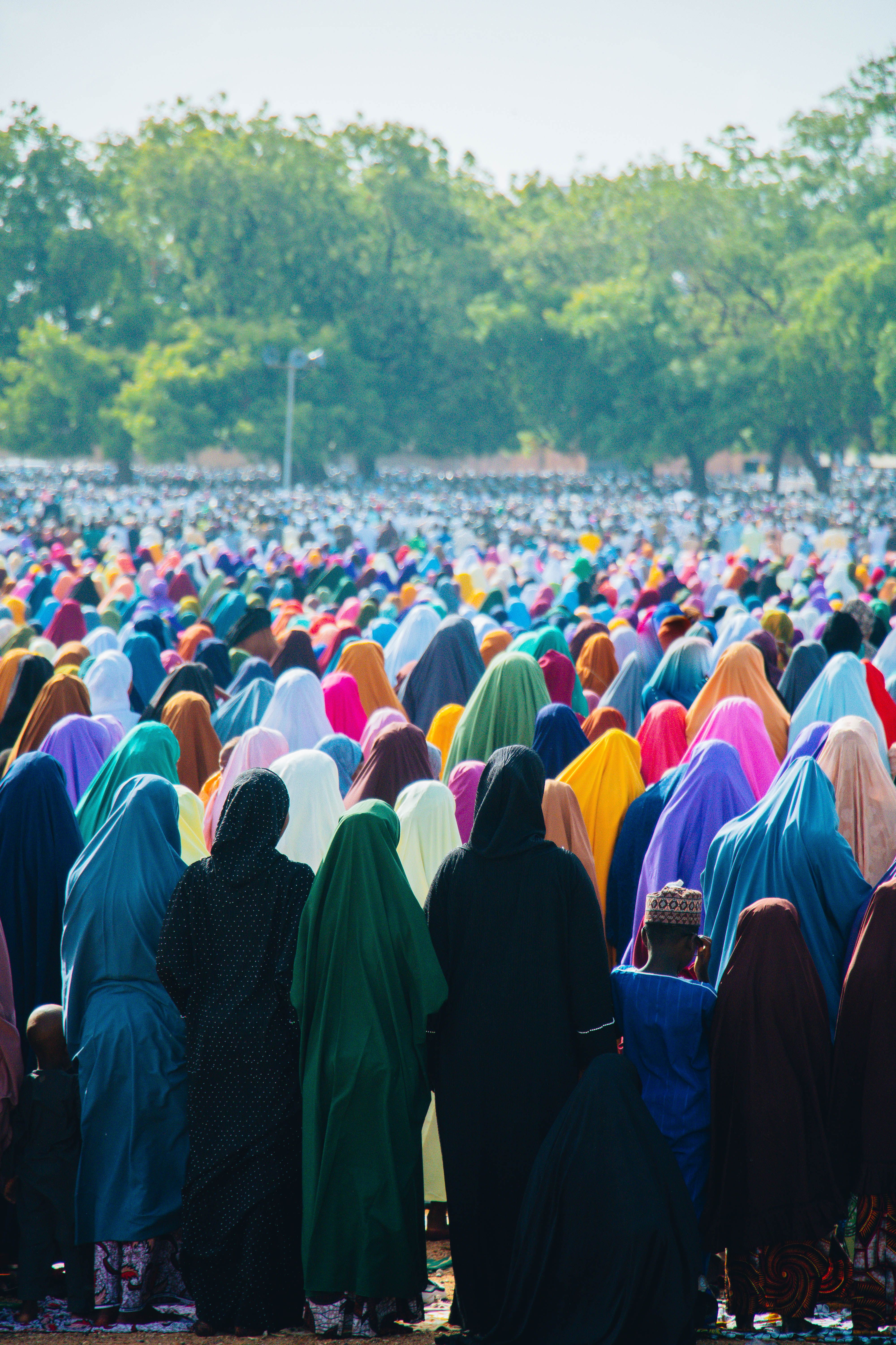 A colorful gathering of individuals in Zaria, Nigeria, showcasing cultural diversity during a daylight event.