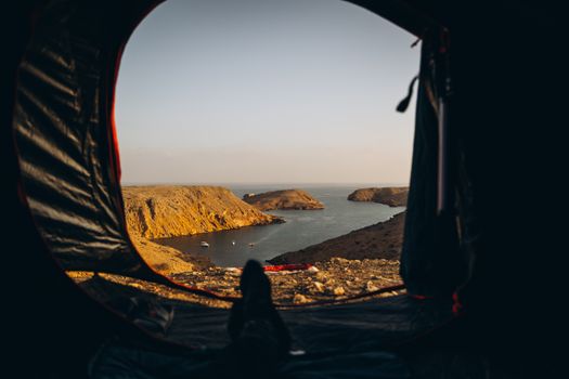 Explore a stunning coastal view from a tent in Muscat, Oman. Perfect for travel enthusiasts.