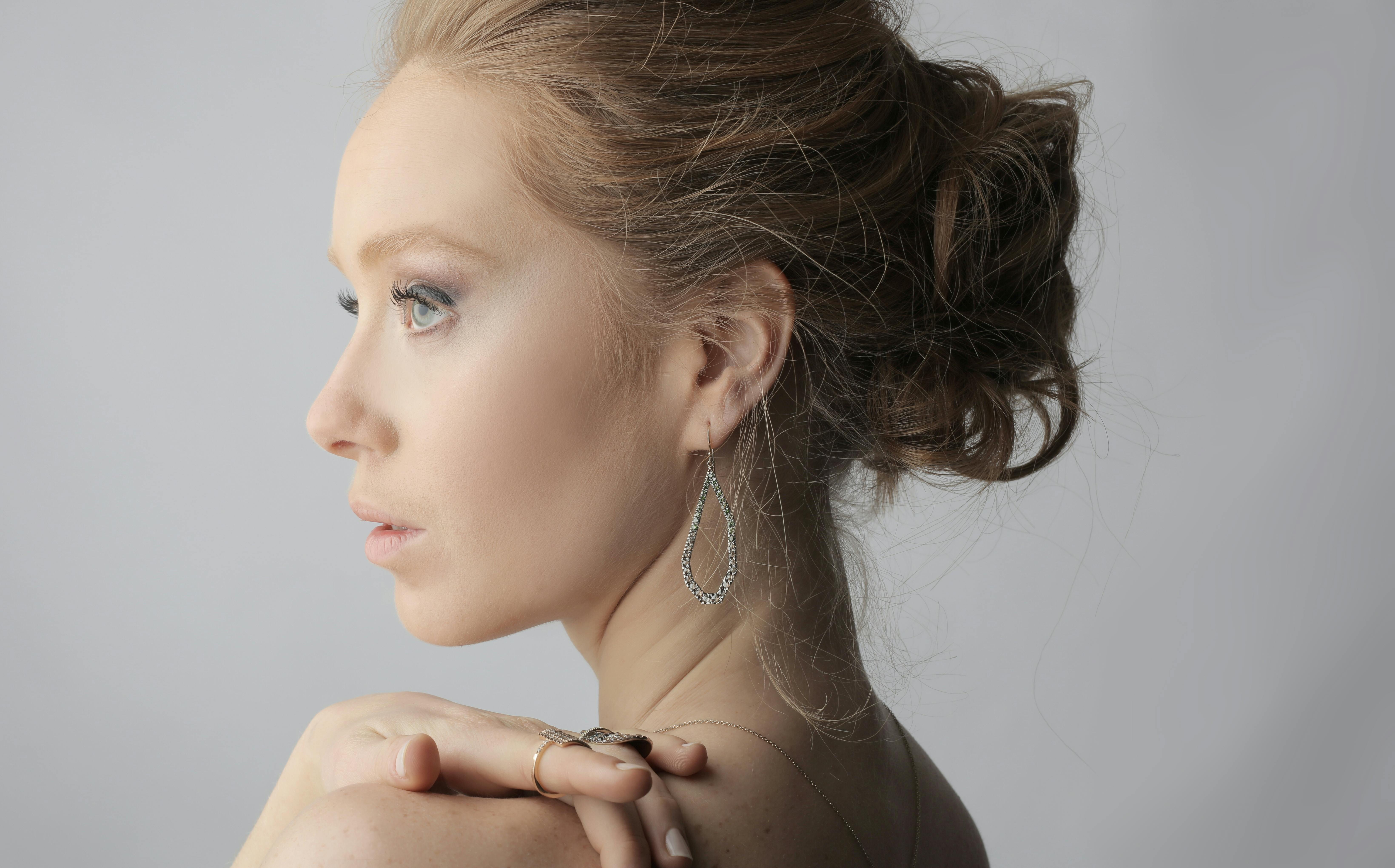 Woman With Brown Hair Wearing Silver Rings and Earring · Free Stock Photo