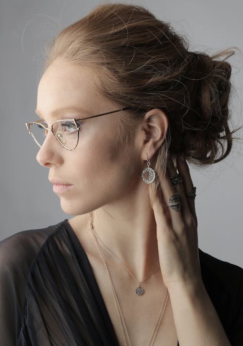 Woman in Black V Neck Shirt Wearing Silver Framed Eyeglasses