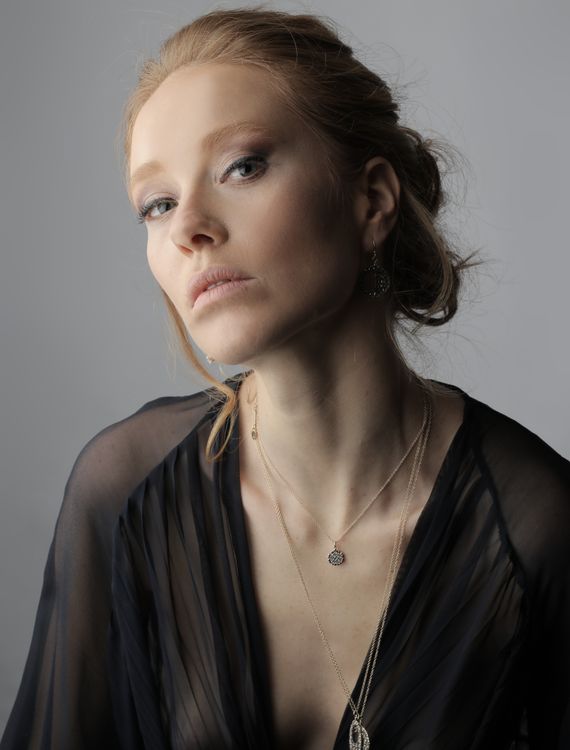 Woman in Black Shirt Wearing Silver Necklace · Free Stock Photo