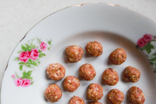 Free Close-up of delicious meatballs arranged on a floral plate for a delightful meal. Stock Photo