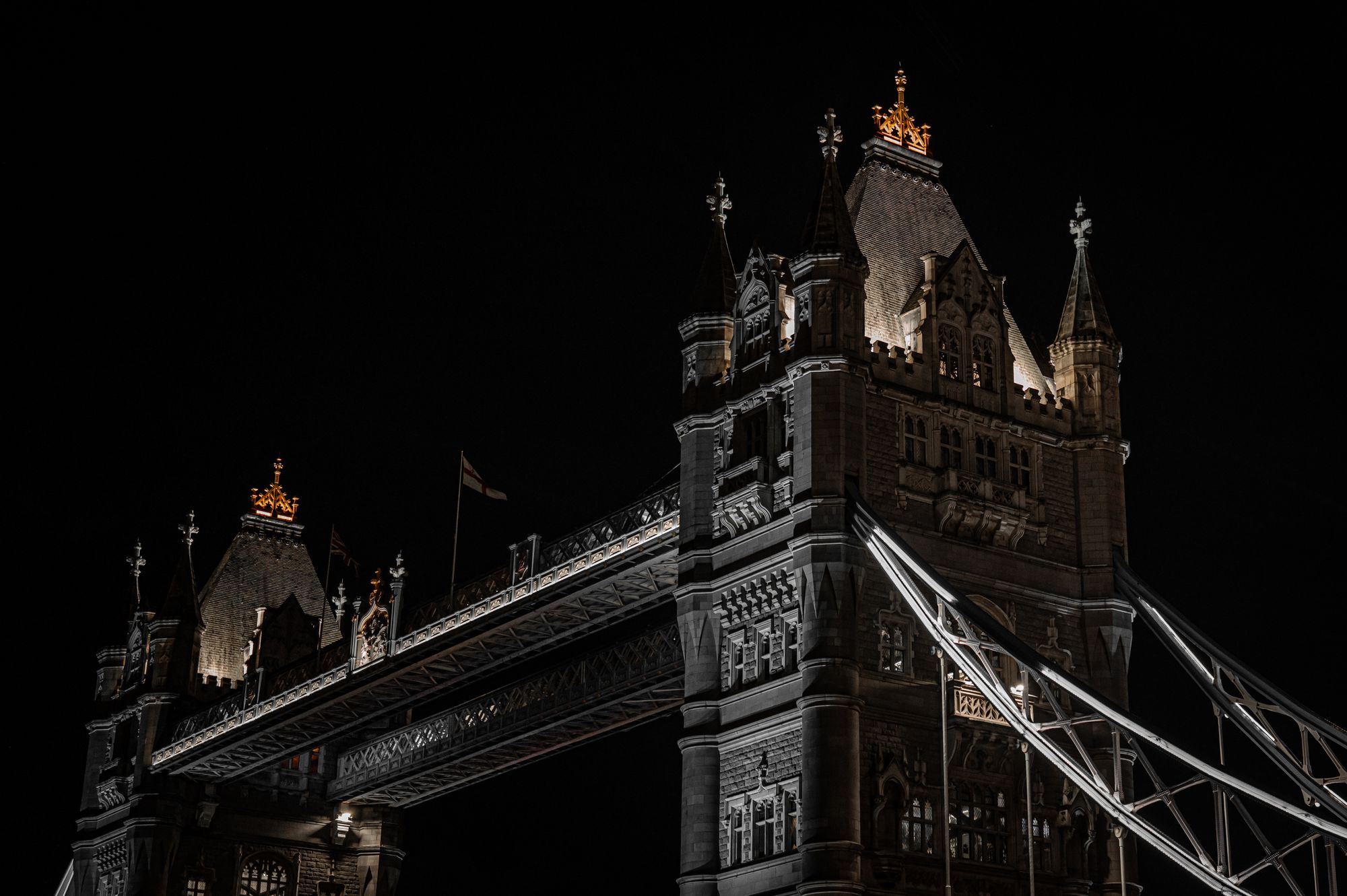 Night view of London’s iconic Tower Bridge with dramatic lighting.