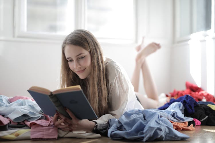 Woman Lying Down While Reading A Book