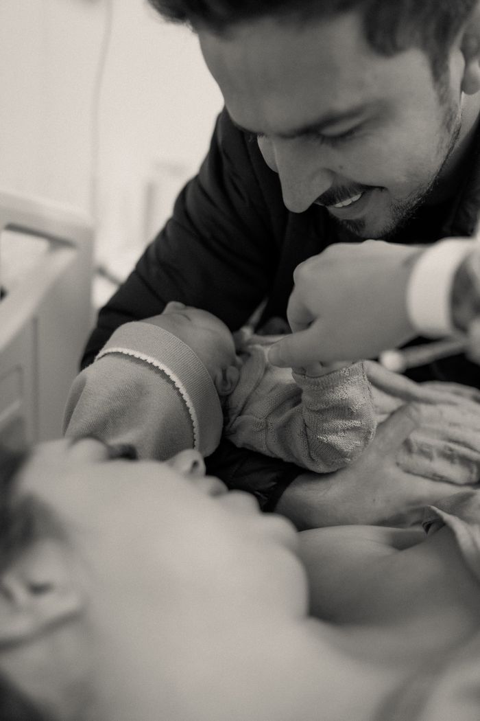 Parents bonding with their newborn in a hospital room — photo by Alexander Mass on Pexels