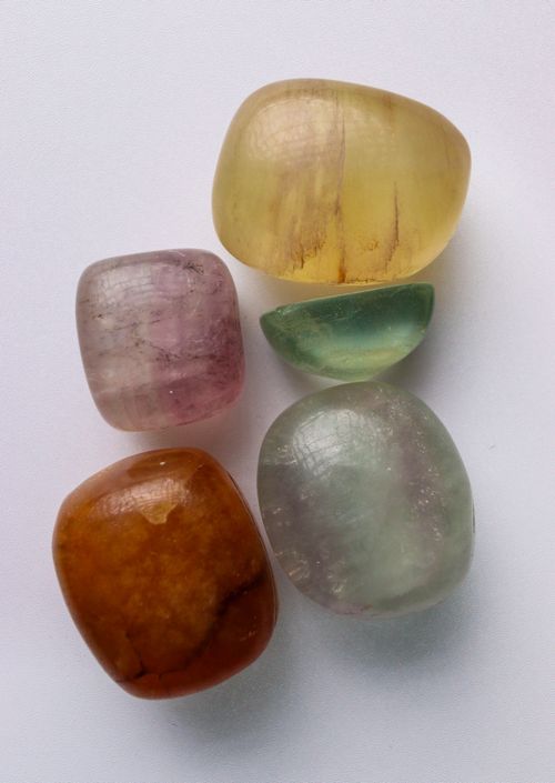 Free A collection of vibrant tumbled healing crystals featuring different colors and textures. Stock Photo