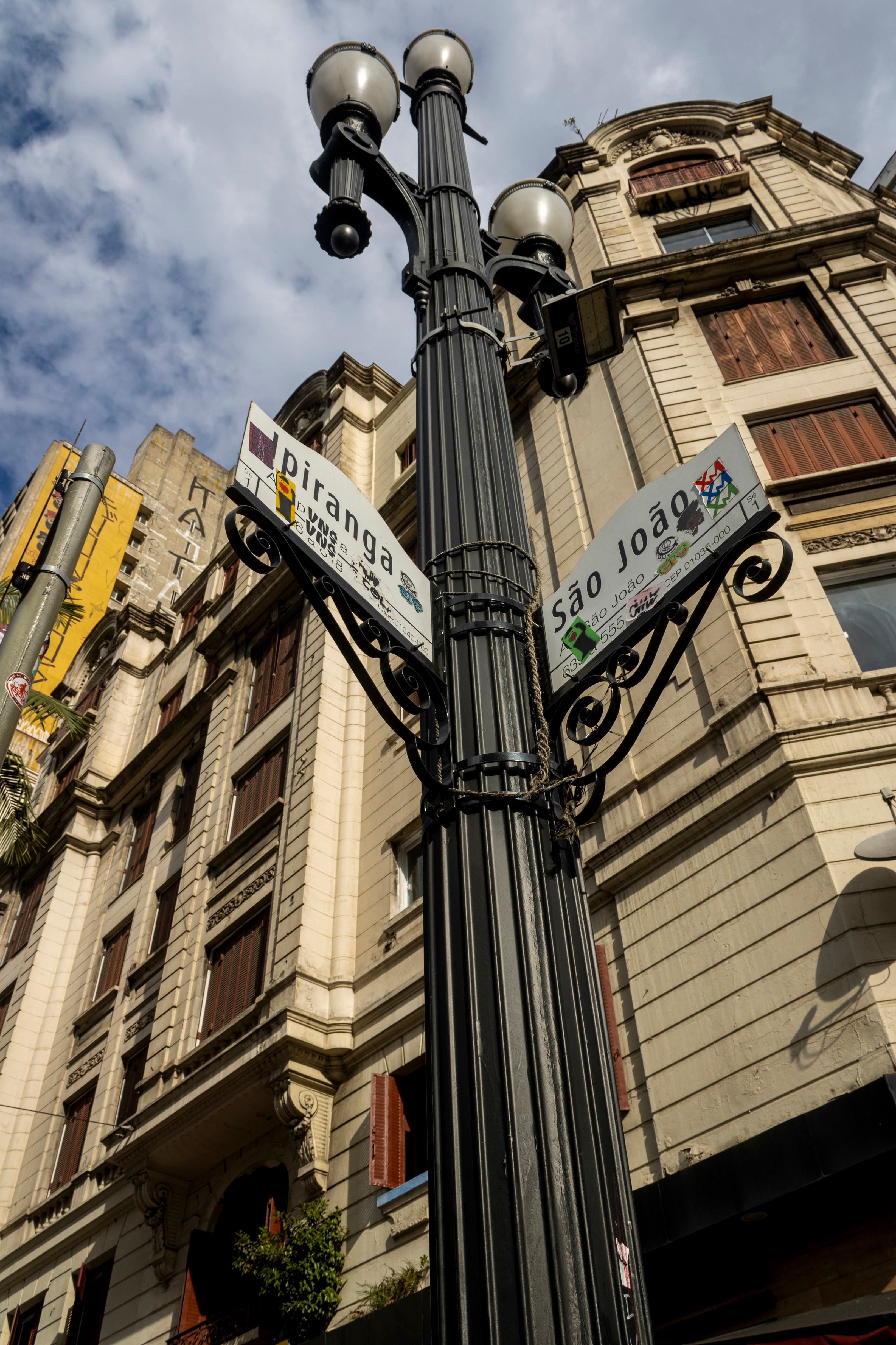 Street corner view with signs in historic São Paulo architecture under a clear sky.