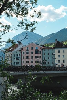 Picturesque view of colorful houses in Innsbruck, Austria, with the Alps in the background.