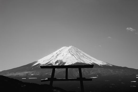 Black and white image of Mount Fuji with a Torii gate silhouette in Fujikawaguchiko, Japan.