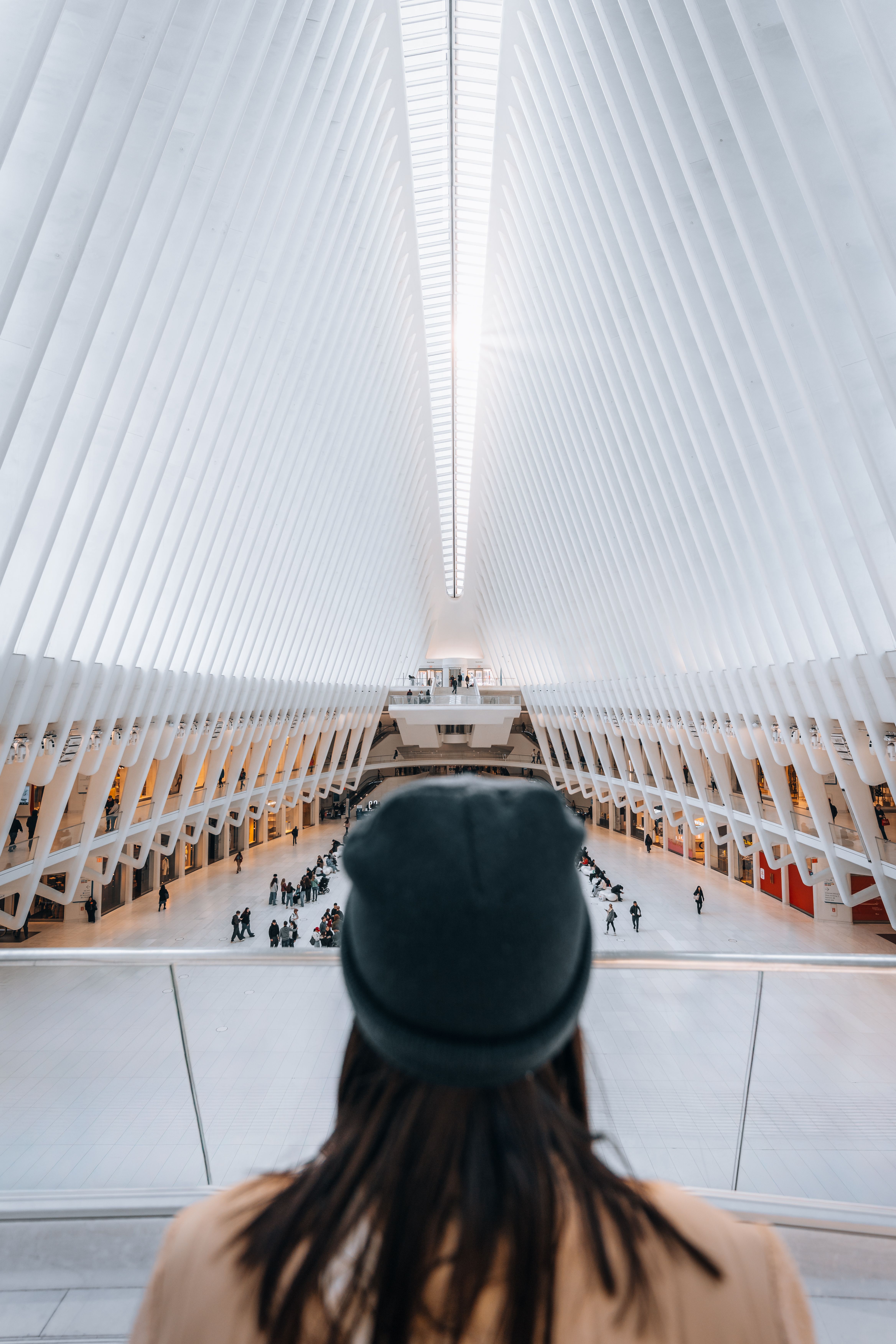 Person observing inside The Oculus, a futuristic transit hub in New York City.