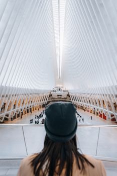 Person observing inside The Oculus, a futuristic transit hub in New York City.
