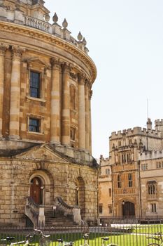A sunny view of the iconic Radcliffe Camera and surrounding structures in Oxford, UK.