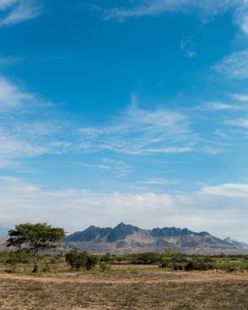 Beautiful landscape of mountains and plains in Ascope, La Libertad, Perú under a clear blue sky.
