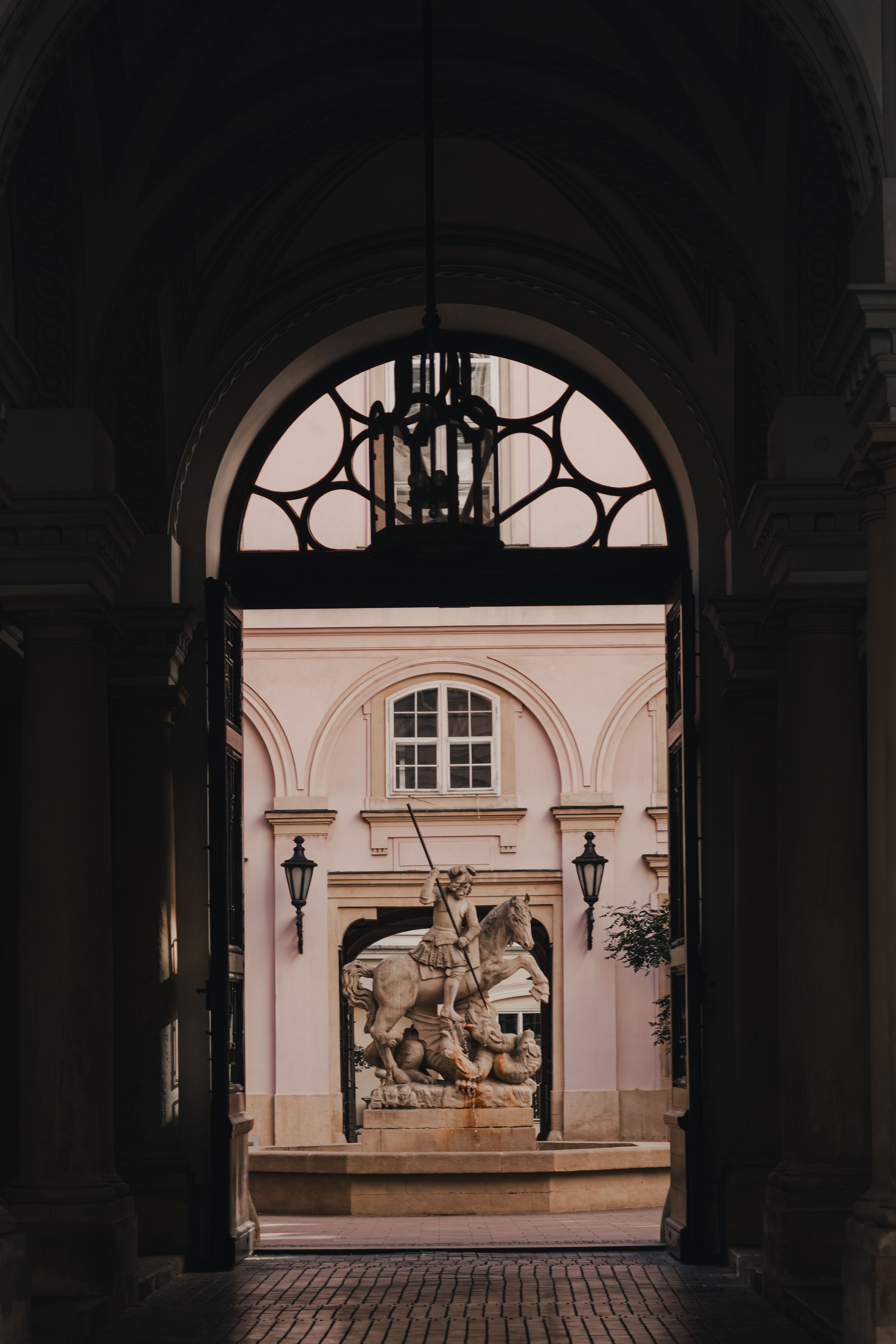 View through an archway of a historic statue in the Baroque architecture of Bratislava, Slovakia.
