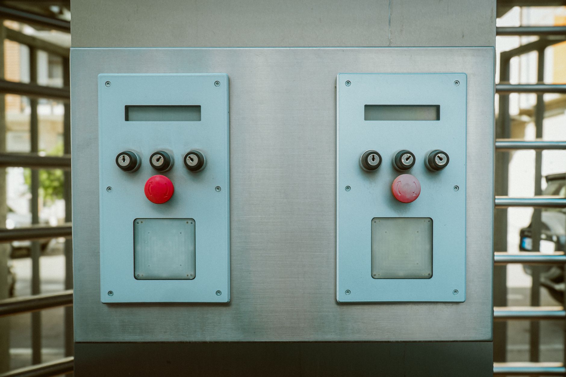 Close-up of a symmetrical metal control panel with red buttons in Tbilisi, Georgia.