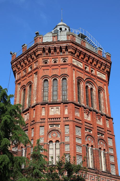 Free Red brick historic tower in İstanbul, showcasing rich architectural detail against a clear blue sky. Stock Photo