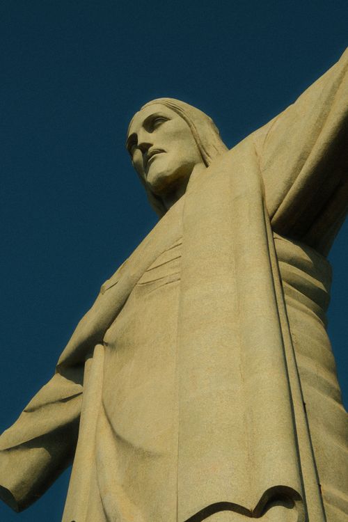 Free Low-angle view of the iconic Christ the Redeemer statue under a clear blue sky in Rio de Janeiro. Stock Photo