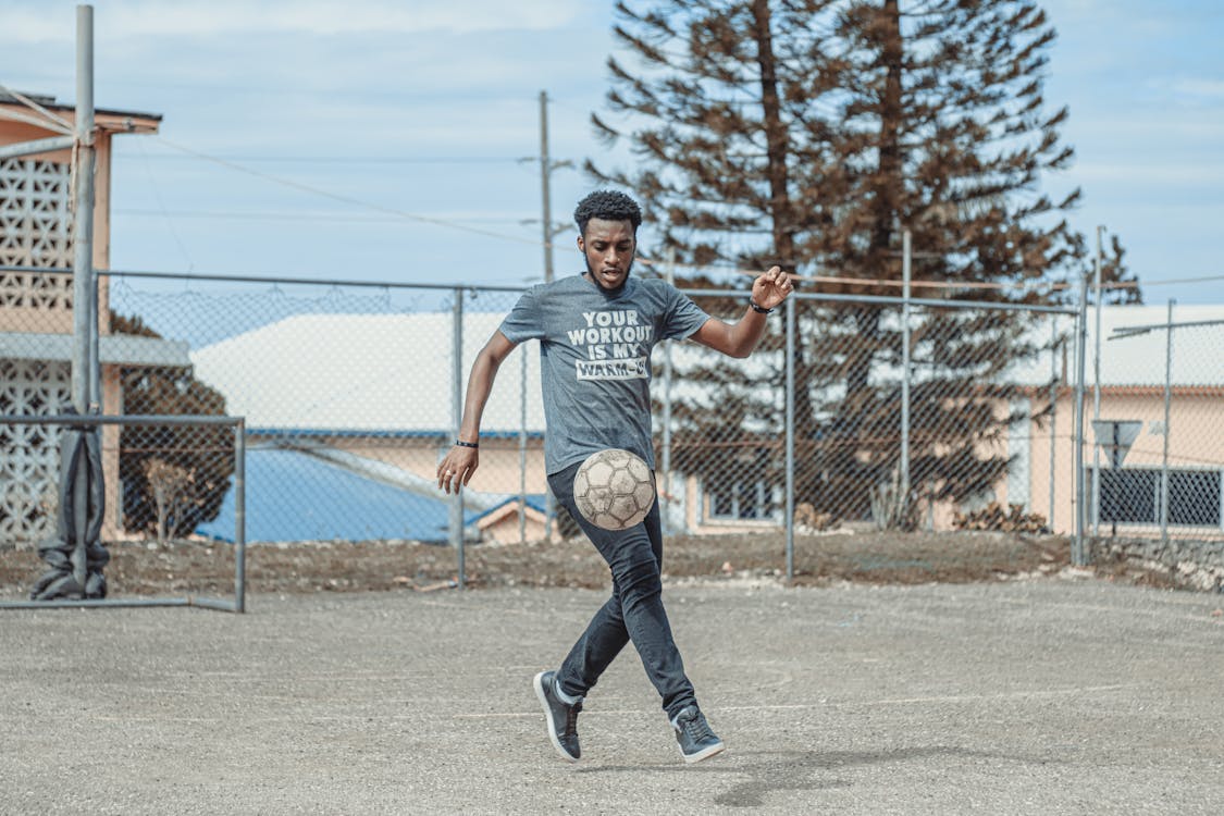 Man in Gray Crew Neck T-shirt and Black Pants Playing Basketball