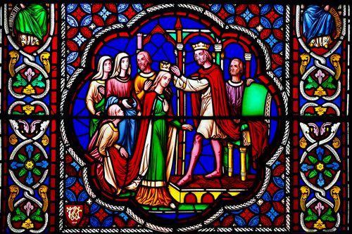 Free Vibrant stained glass artwork in an English cathedral showcasing a regal coronation with intricate designs. Stock Photo