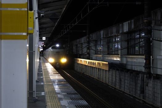 Night view of an express train arriving at Shizuoka Station, Japan.