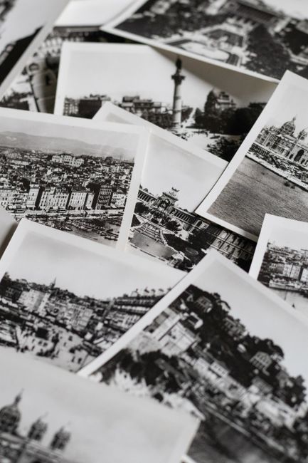 Collection of vintage black and white postcards featuring cityscapes, evoking nostalgia.