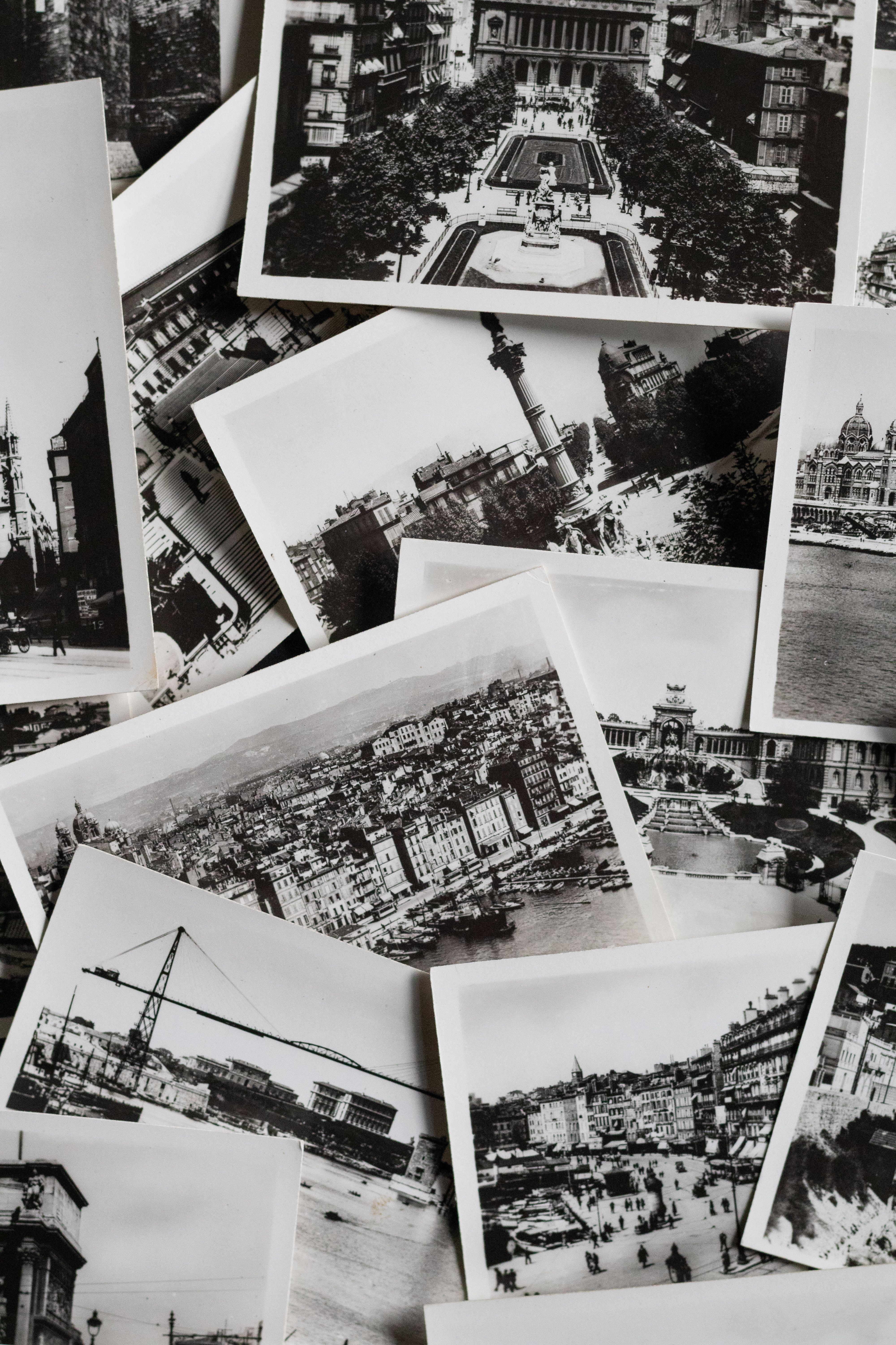 Scattered vintage black and white photographs of iconic places. Perfect for a nostalgic or historical theme.