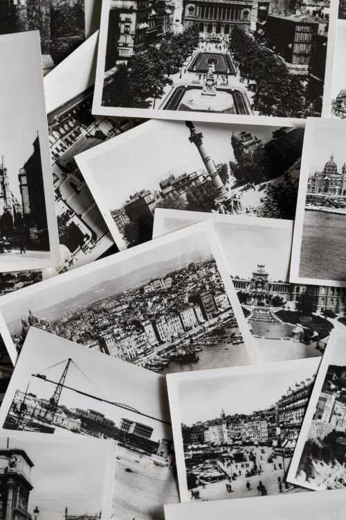 Free Scattered vintage black and white photographs of iconic places. Perfect for a nostalgic or historical theme. Stock Photo