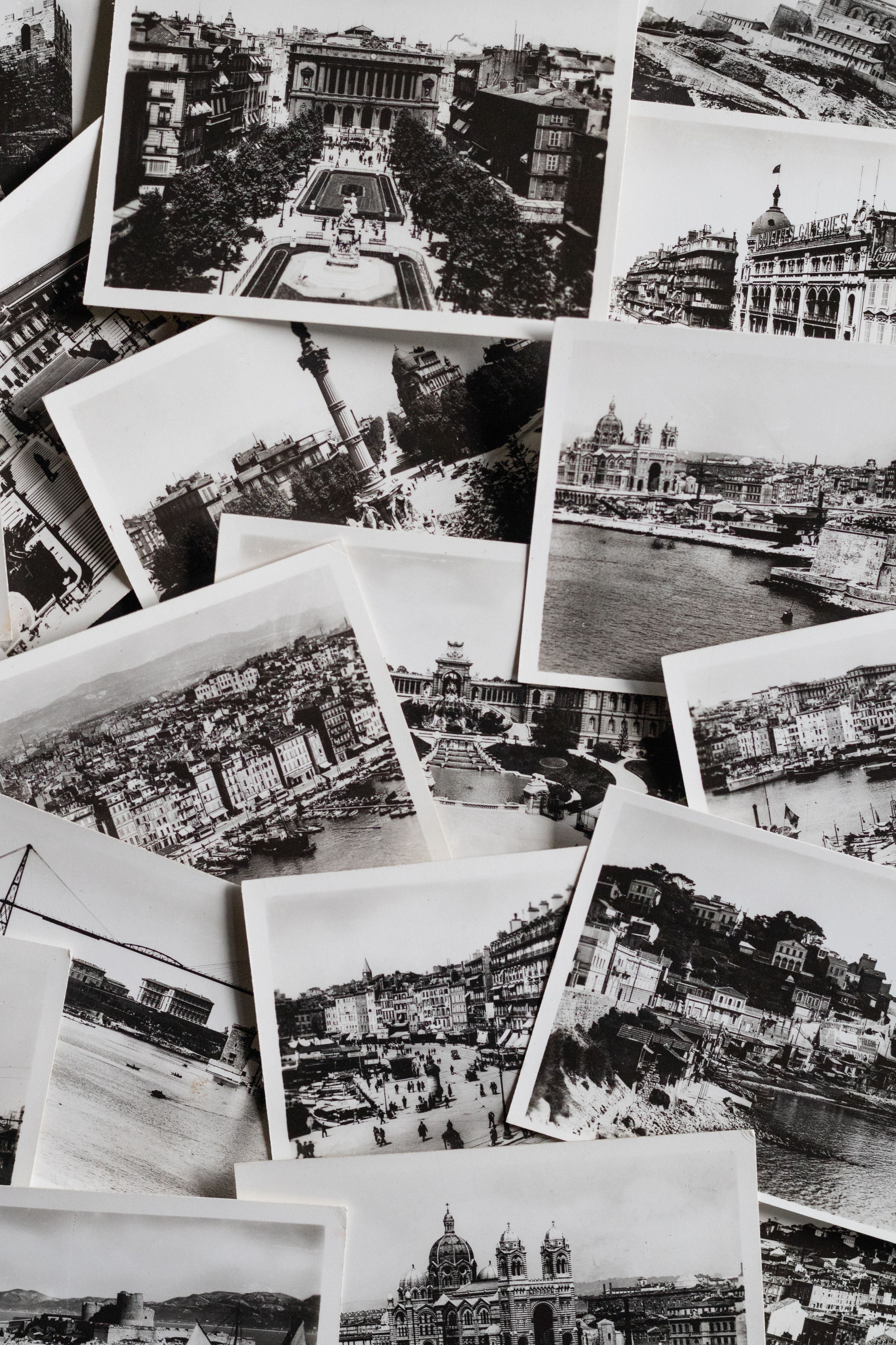 A collection of vintage black and white printed photos featuring European landmarks.