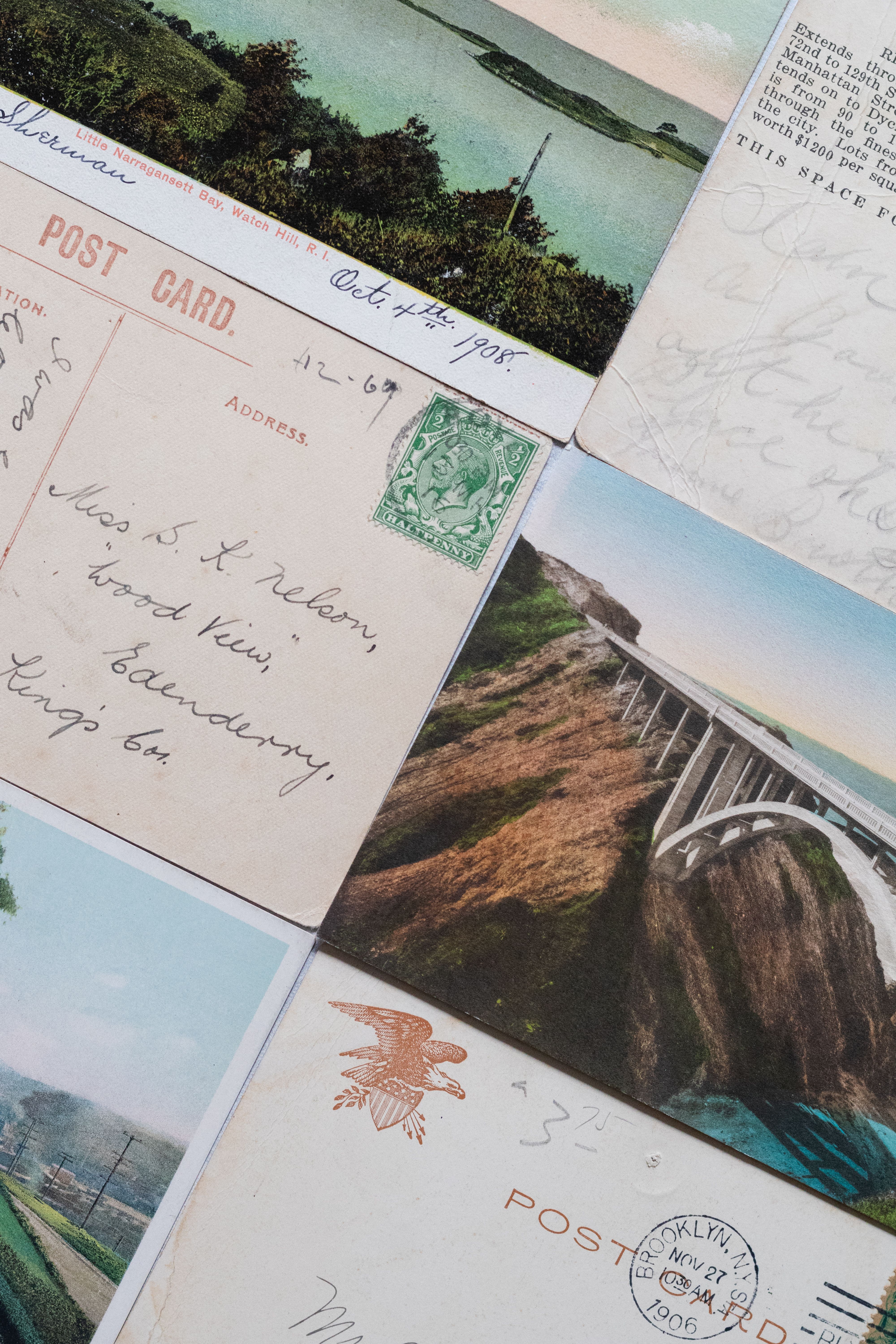 Collection of vintage postcards showcasing 1900s scenes with handwritten text and stamps.